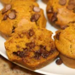Fluffy and moist pumpkin chocolate chip muffins on a cooling rack
