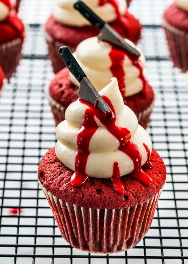 Halloween red velvet cupcakes with spooky decorations and cream cheese frosting